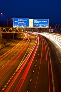 Light trails on road in city at night