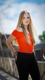 Portrait of young woman standing in city