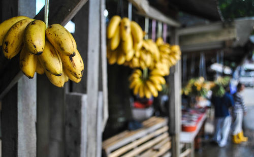 Close-up of yellow bananas hanging outdoors