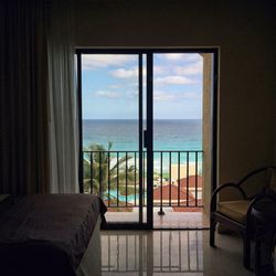 View of calm sea seen through window