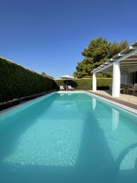 Swimming pool against clear blue sky