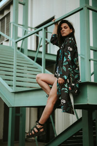 Young woman standing on staircase