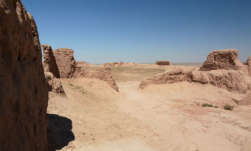 Rock formations on landscape against clear sky