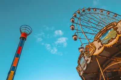 Low angle view of ferris wheel against clear blue sky