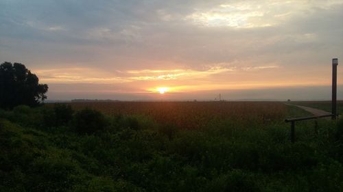 Scenic view of landscape against sky at sunset