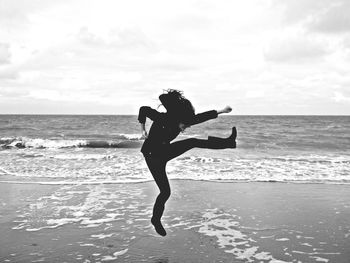 Woman jumping on beach