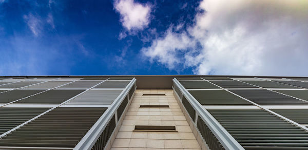 Low angle view of apartment building against blue sky