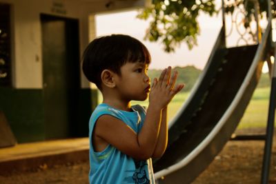 Side view of young woman drinking water
