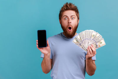 Portrait of boy holding mobile phone