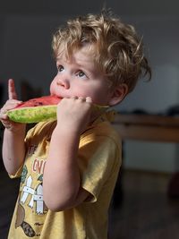 Close-up of girl eating food at home