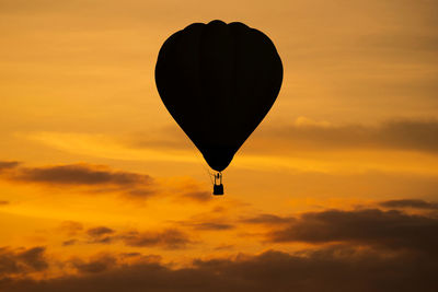 Low angle view of hot air balloon against orange sky