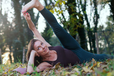 Mature woman exercising in forest