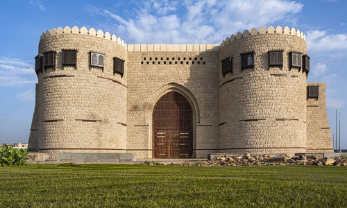 View of castle on field against sky