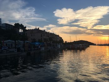 Reflection of buildings in water at sunset