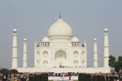 Group of people in front of building against clear sky