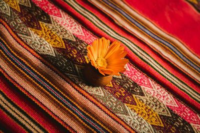 Small flower ornament on a table in a restaurant with beautiful and colorful textiles