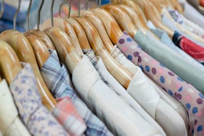 Various clothes displayed for sale at store