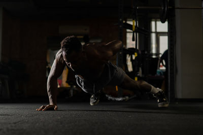 Side view of woman exercising in gym