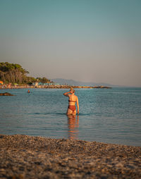 Young woman at italian beach while sunset