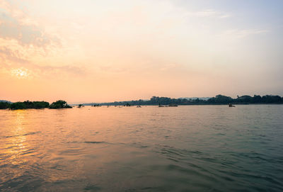 Scenic view of river at sunset