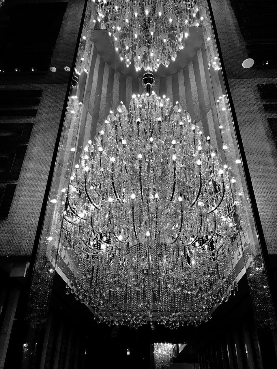 LOW ANGLE VIEW OF ILLUMINATED CHANDELIER