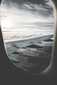 View of cloudy sky seen through airplane window