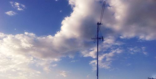 Low angle view of power lines against sky