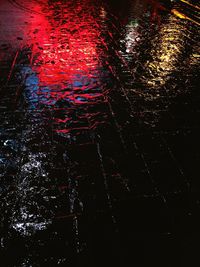 High angle view of wet footpath at night