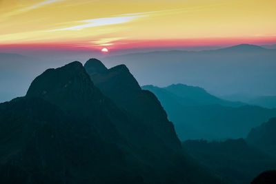 Scenic view of silhouette mountains against sky during sunset