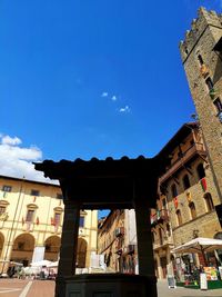 Low angle view of buildings against blue sky