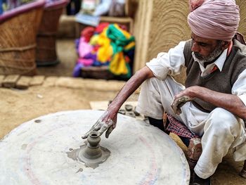 Man working on pottery wheel