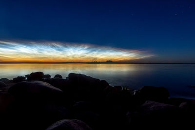 Scenic view of sea against sky at night