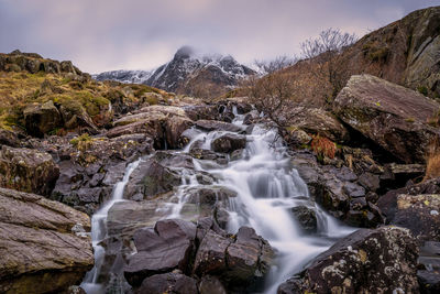 Scenic view of waterfall against sky