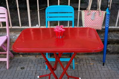 Empty chairs and tables on sidewalk