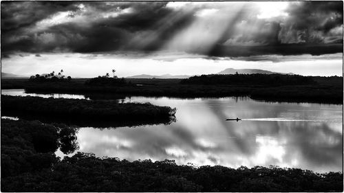 Scenic view of lake against cloudy sky