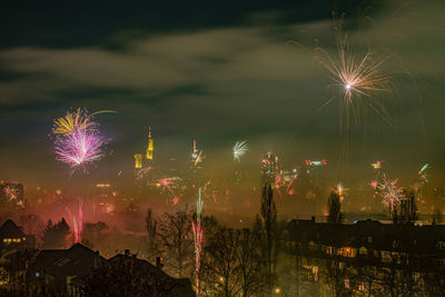 Firework display in city at night