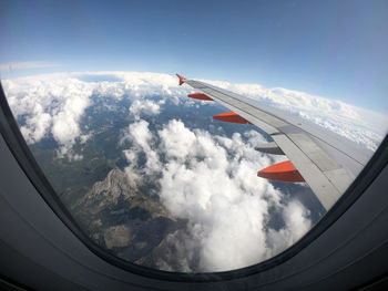 Aerial view of aircraft wing against sky