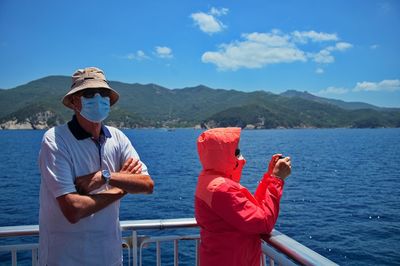 Senior couple with medicine mask on the boat