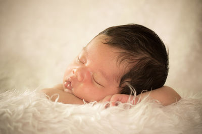 Cute baby boy sleeping on fur