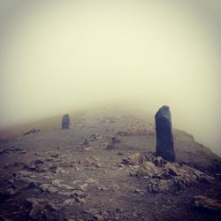 Scenic view of landscape against sky during foggy weather