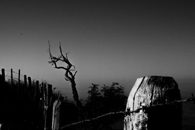 Low angle view of wooden post against sky at dusk