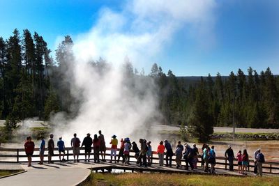 People on mountain against sky