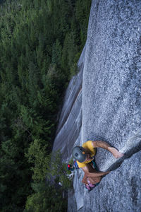 Man lay backing a wide crack high above ground on granite squamish