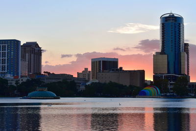 Buildings in city at sunset