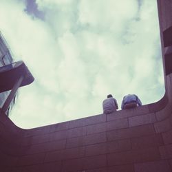 Low angle view of building against cloudy sky