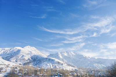 Beautiful mountain landscape in winter in uzbekistan in the area of mount chimgan. cirrus clouds