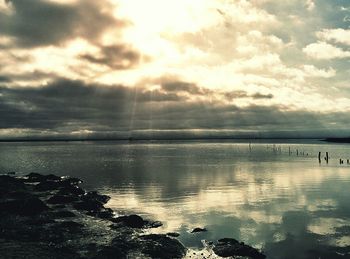 Scenic view of sea against cloudy sky