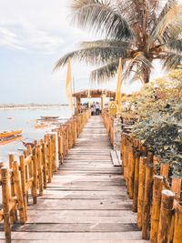 View of palm trees at beach against sky