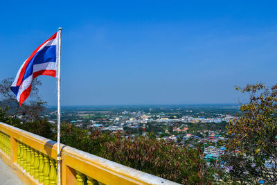 Scenic view of sea and buildings against clear blue sky