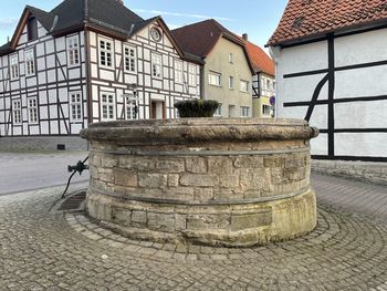 Old building by street in city